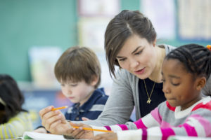 Teacher Helping a Student Understand an Assignment